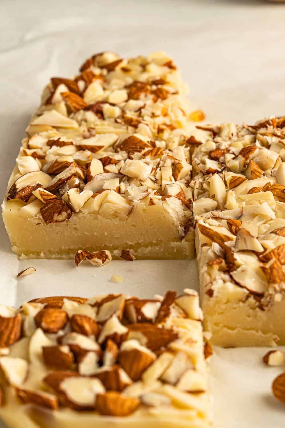 homemade white fudge topped with almonds closeup.