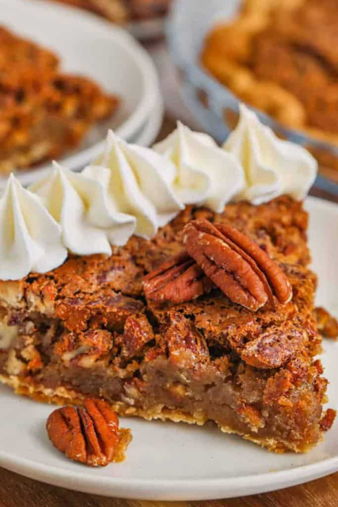 slice of classic pecan pie on plate.