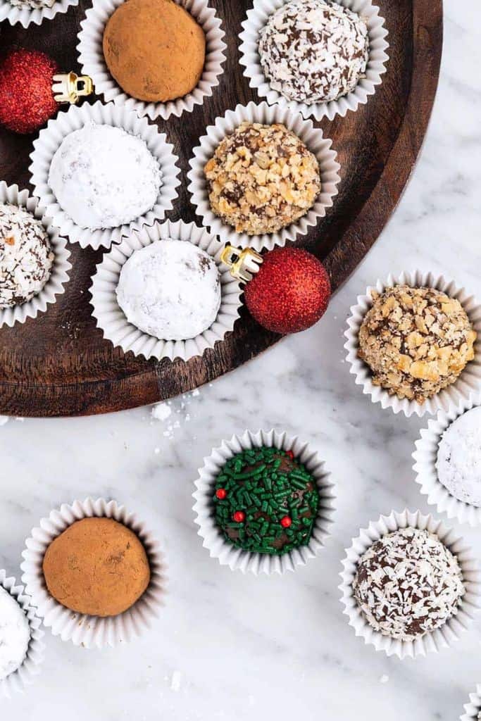 christmas decorated rum balls in paper cases.