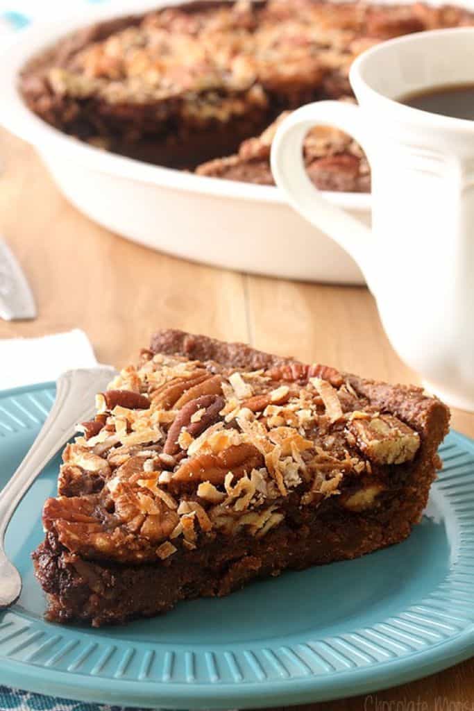 slice of german chocolate pecan pie on blue plate.