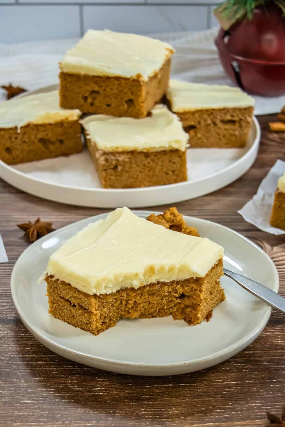 piece of gingerbread sheet cake on plate with fork.