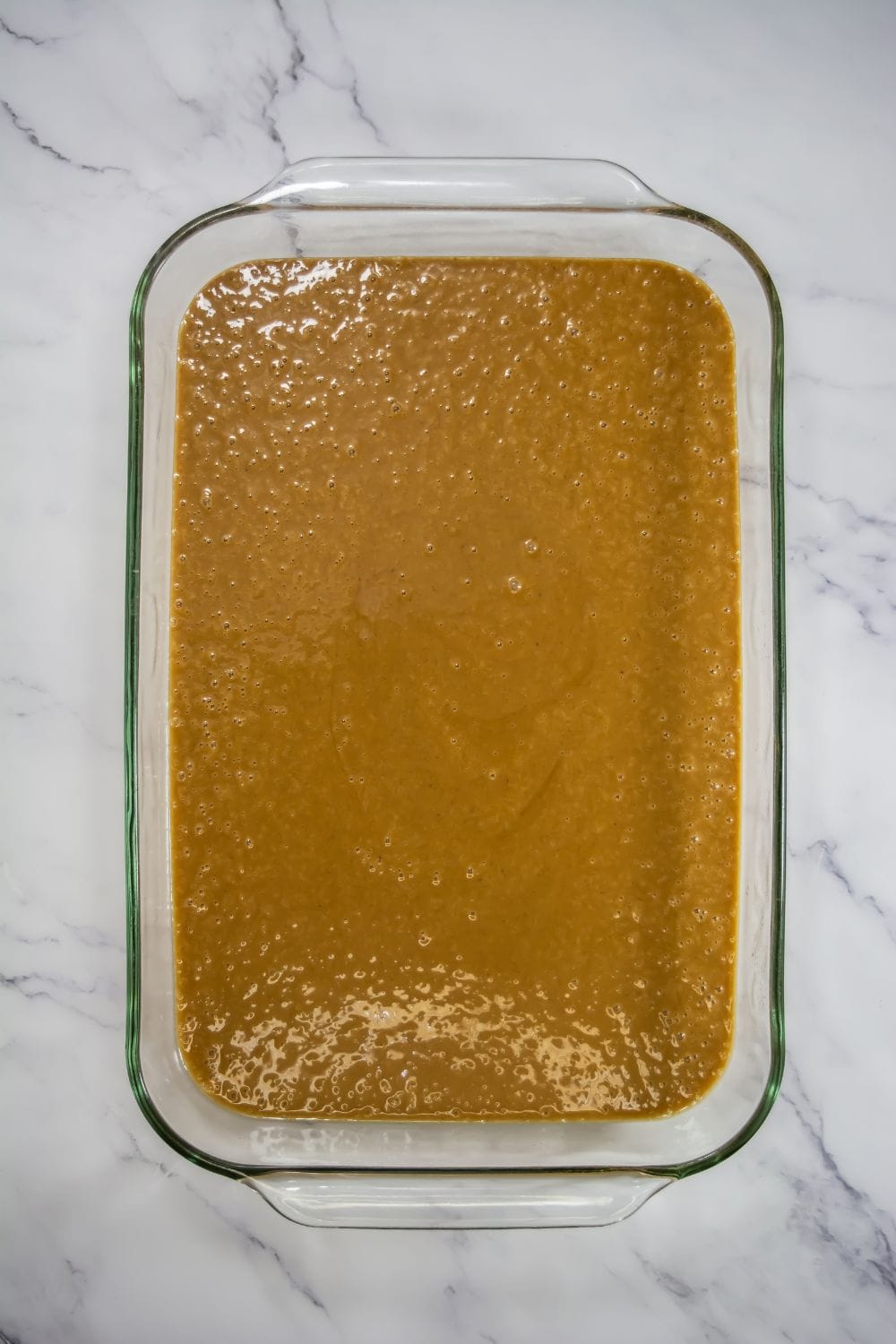 gingerbread cake mixture in glass 9x13 pan.