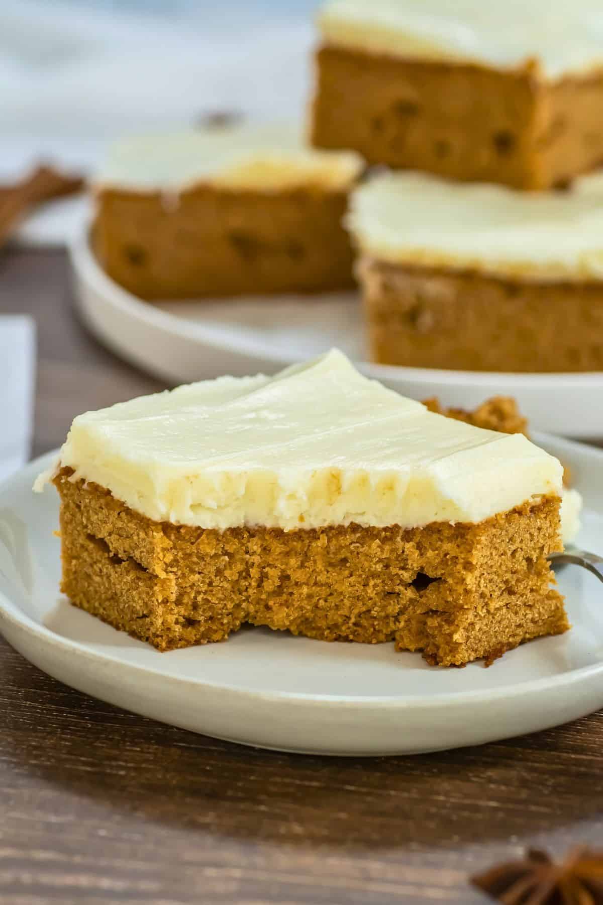 frosted gingerbread cake slice on plate.