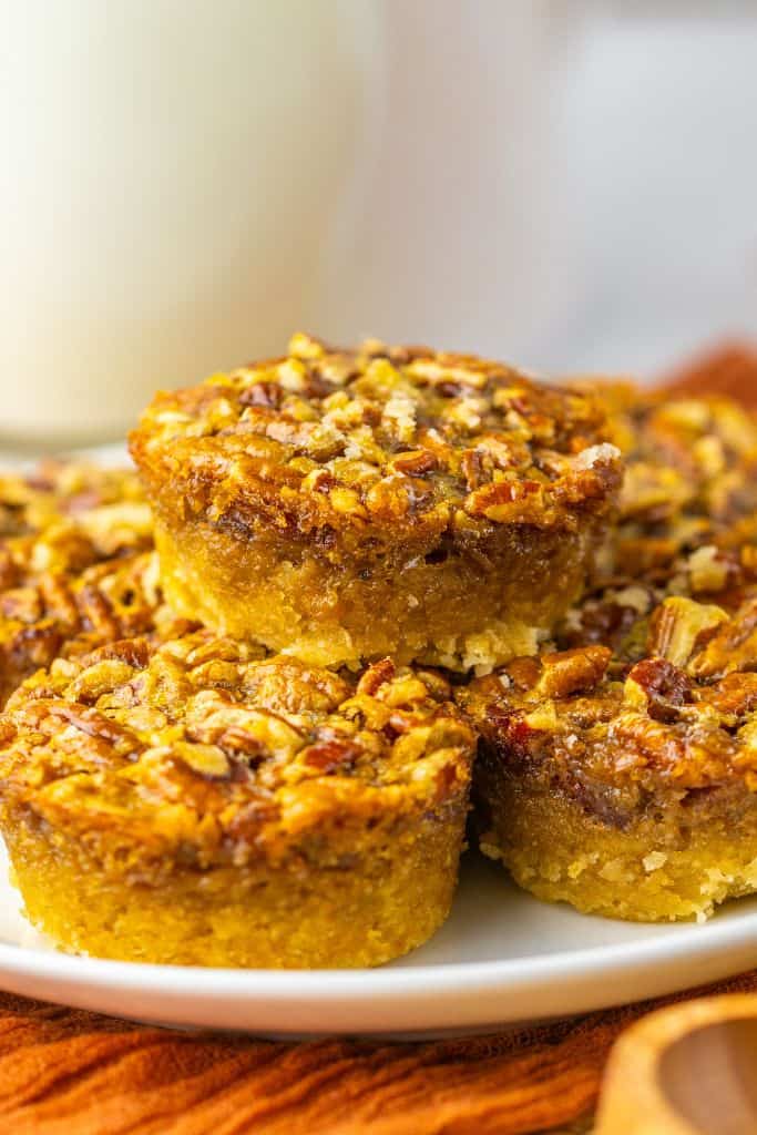 stack of mini pecan pies on plate.