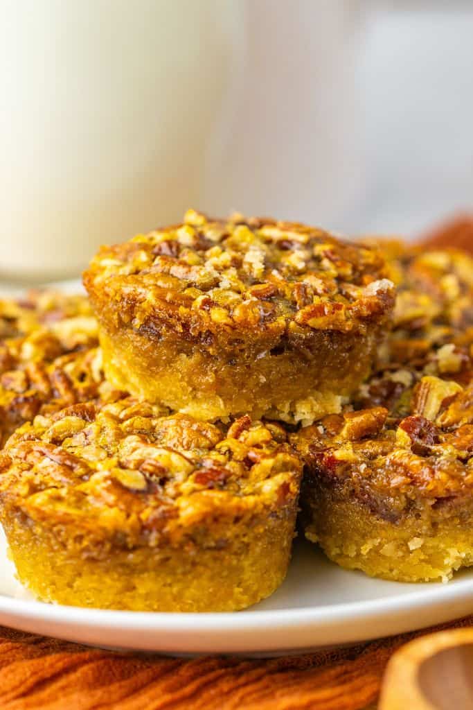 stack of mini pecan pies on plate.