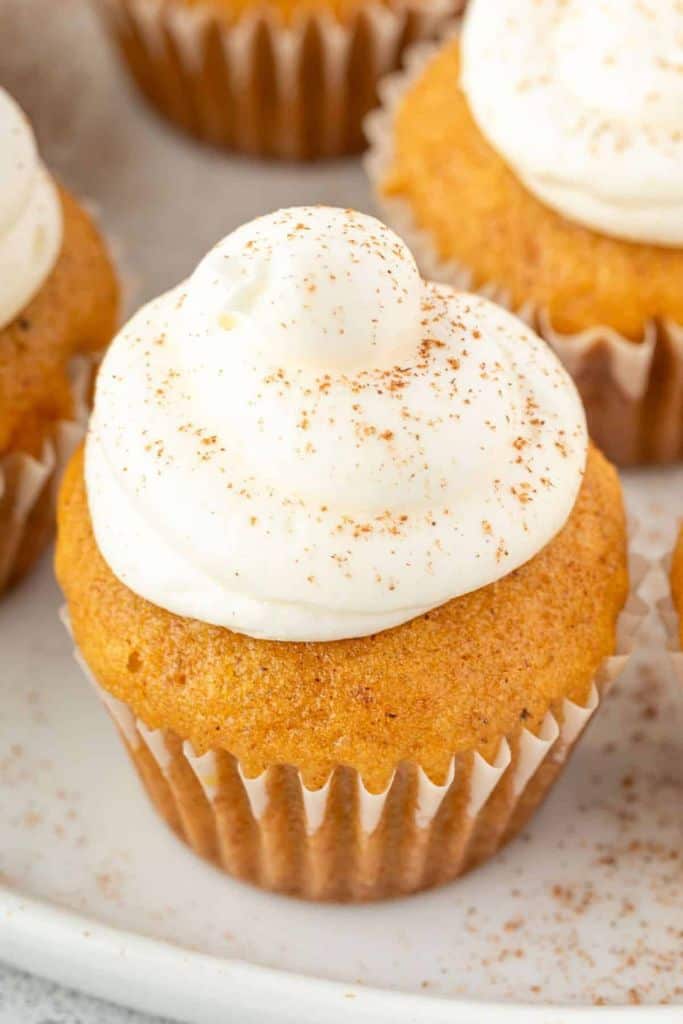 bite sized pumpkin cupcake with frosting.