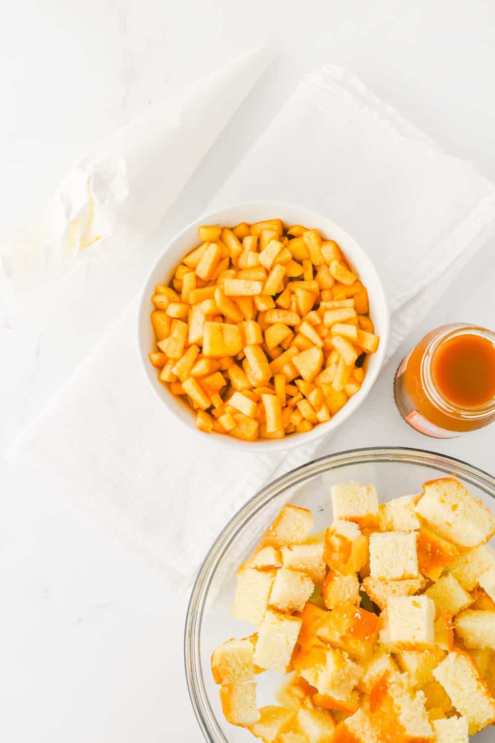 bowls with cooked apples and chopped pound cake.