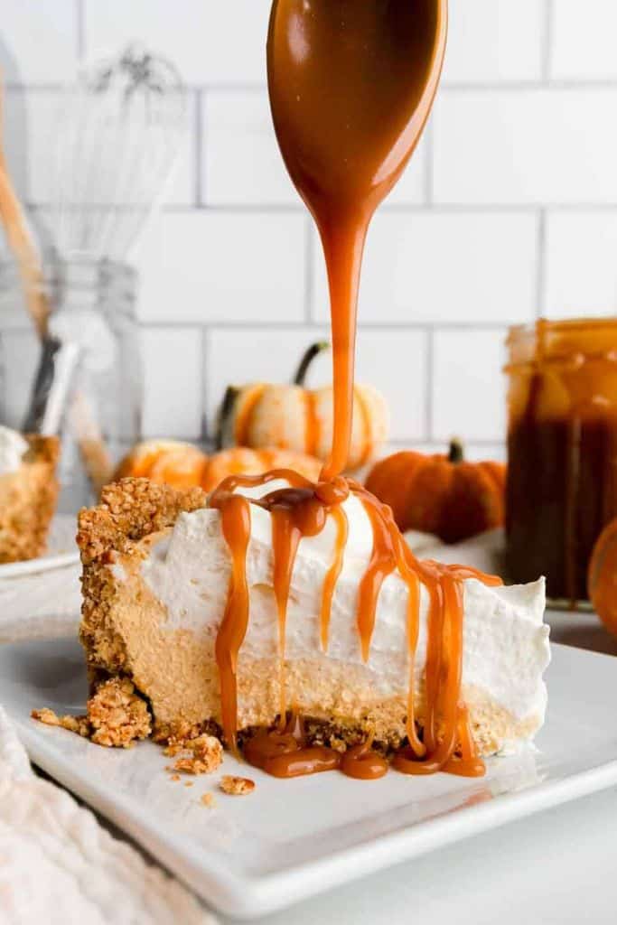 piece of no bake pumpkin pie with salted caramel sauce drizzled on top.