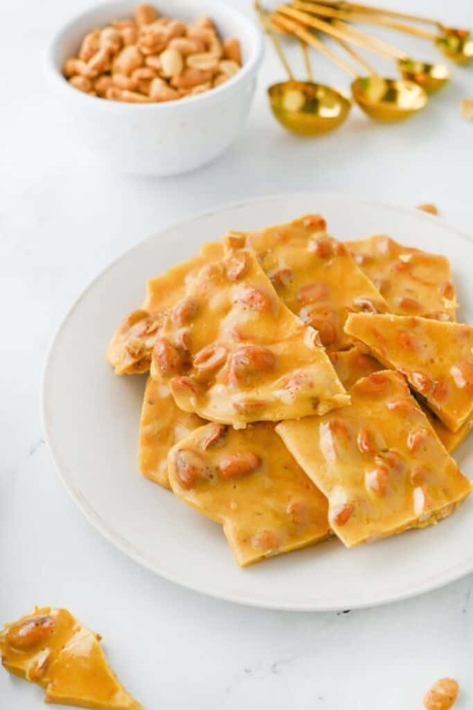 pieces of traditional peanut brittle on plate.