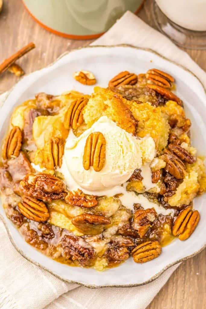 pecan pie cobbler in bowl with icecream.