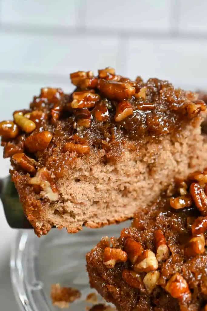 slice of pecan upside down cake lifted from dish.