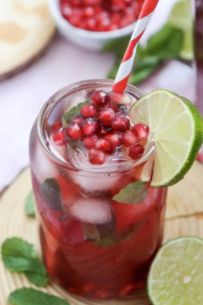 pomegranate mocktail in glass with lime.