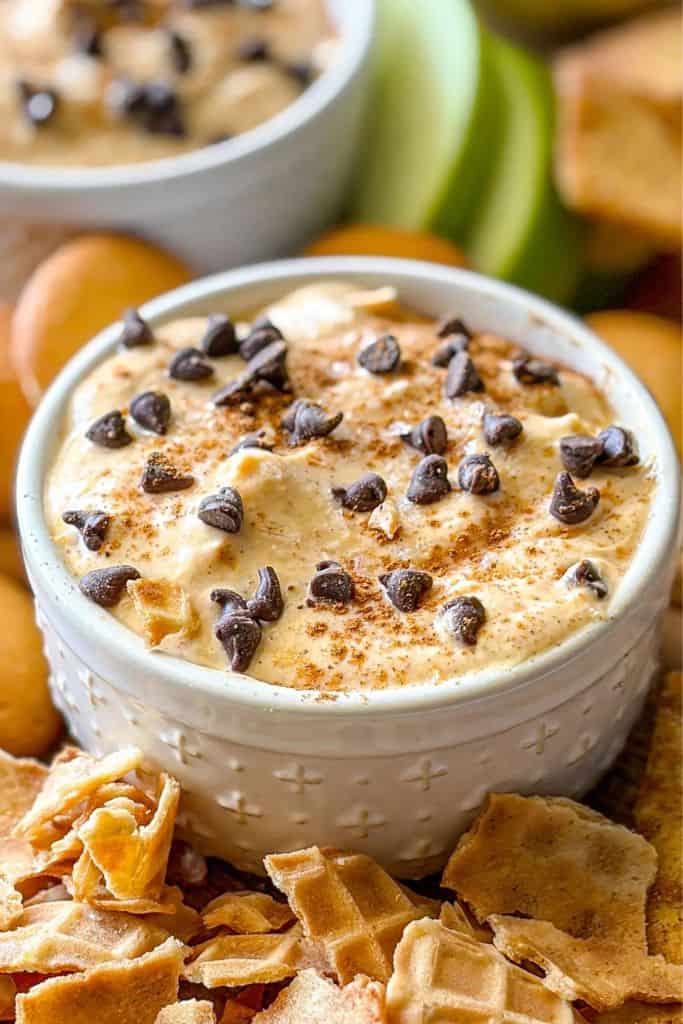 pumpkin cannoli dip in bowl surrounded by dippers.