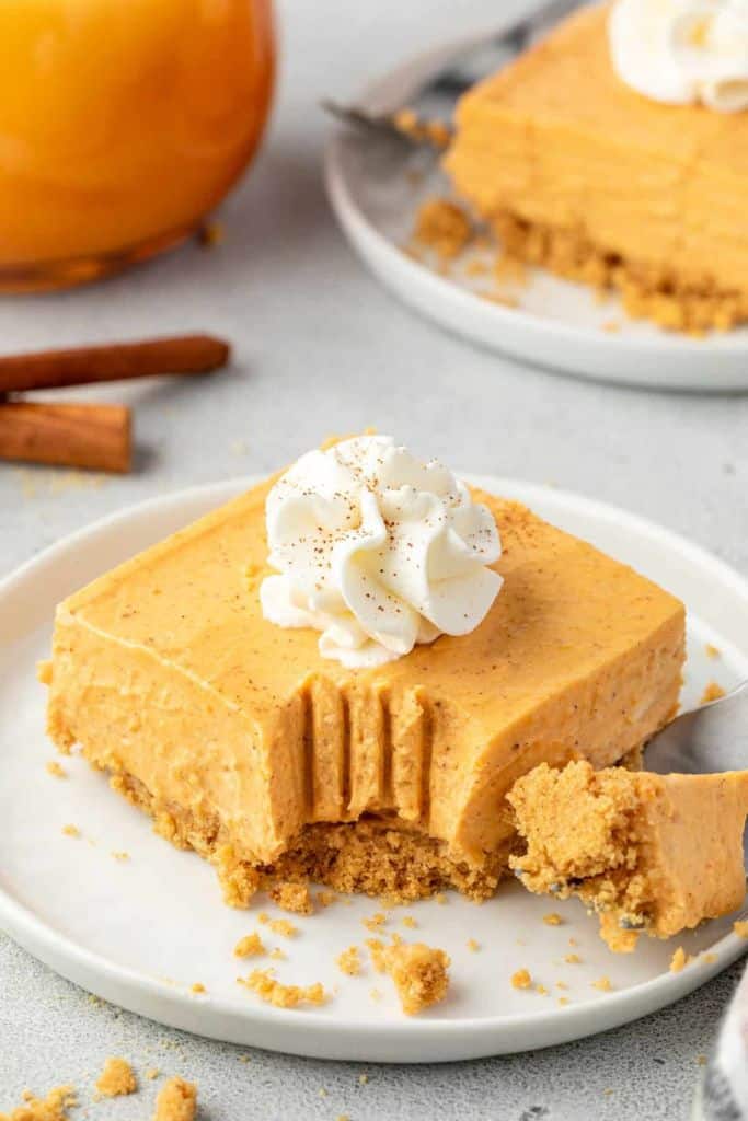 pumpkin cheesecake bar on plate with fork.