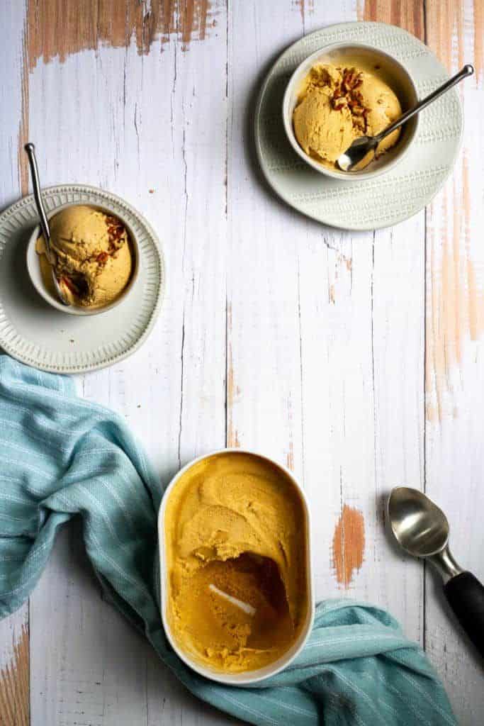 pumpkin ice cream in container and in bowls.