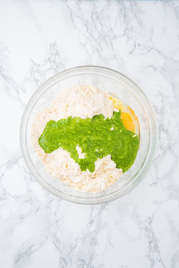 pureed spinach in bowl with scone ingredients.