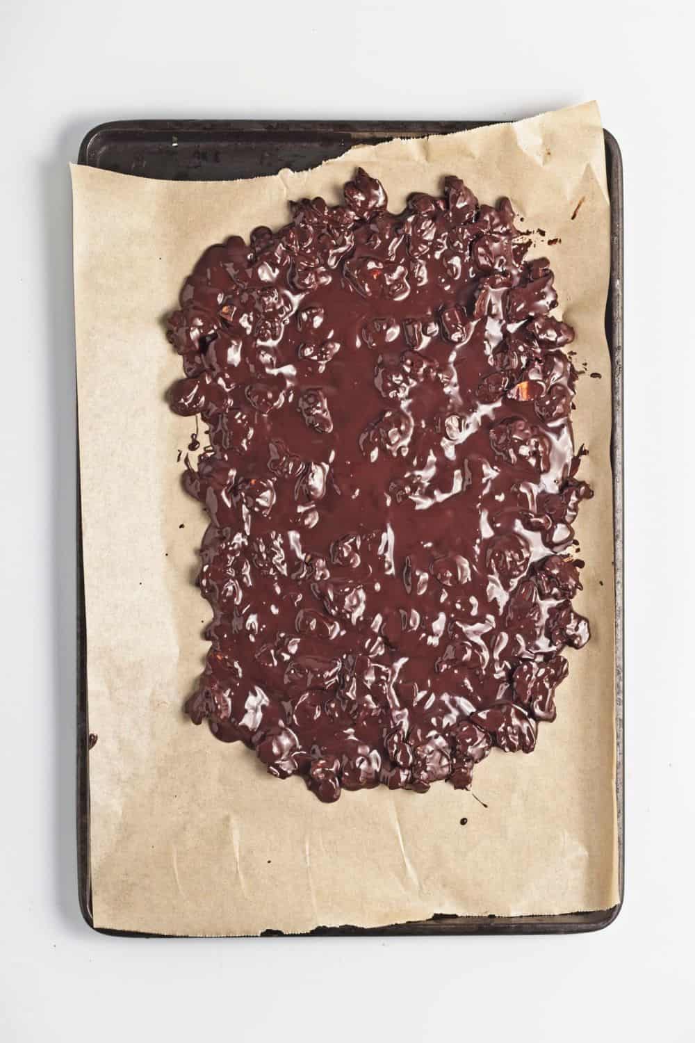 melted chocolate and almonds mixture on tray.