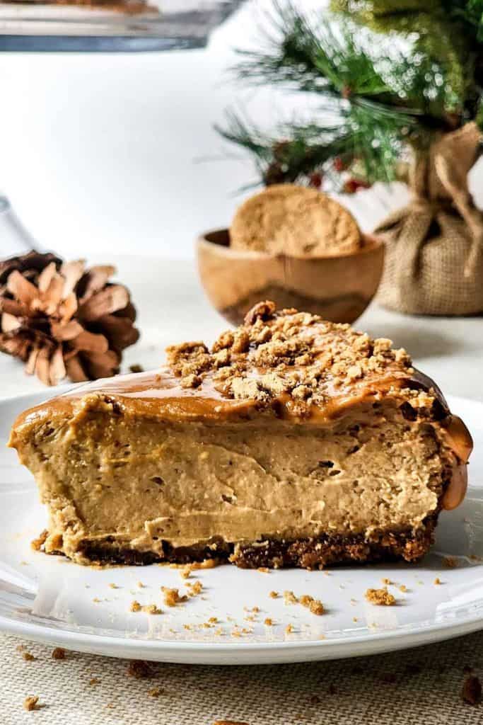 slice of gingerbread baked cheesecake with caramel topping on plate.