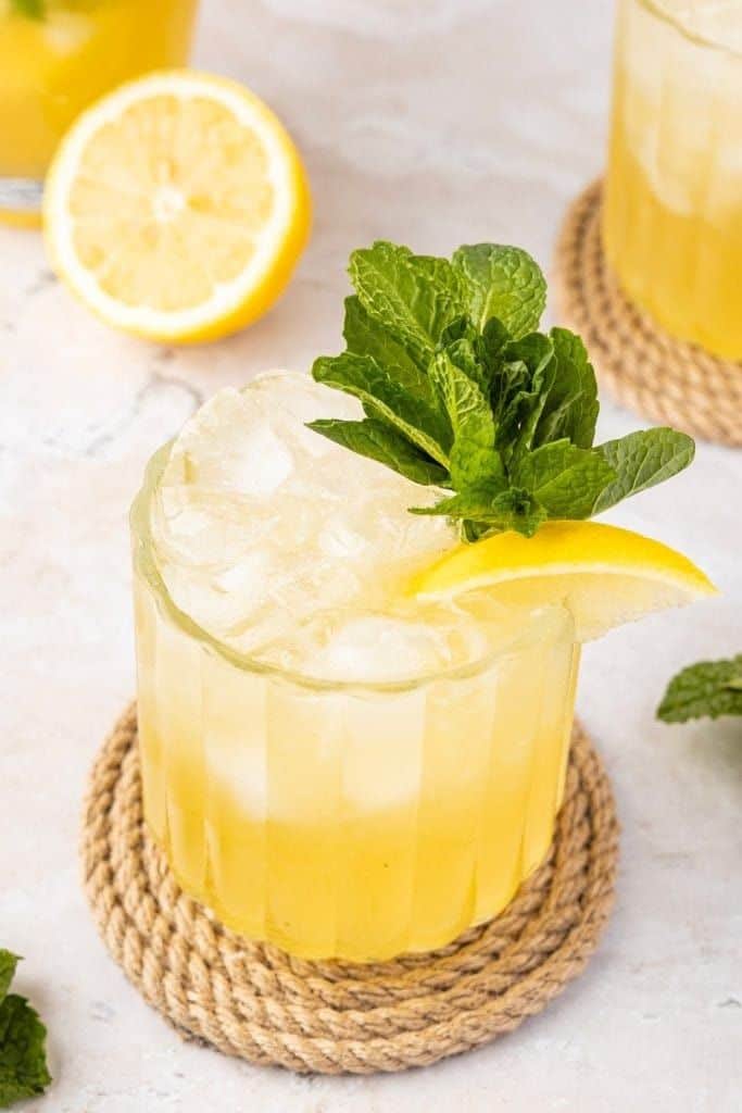 bourbon smash drink in short glass with mint.