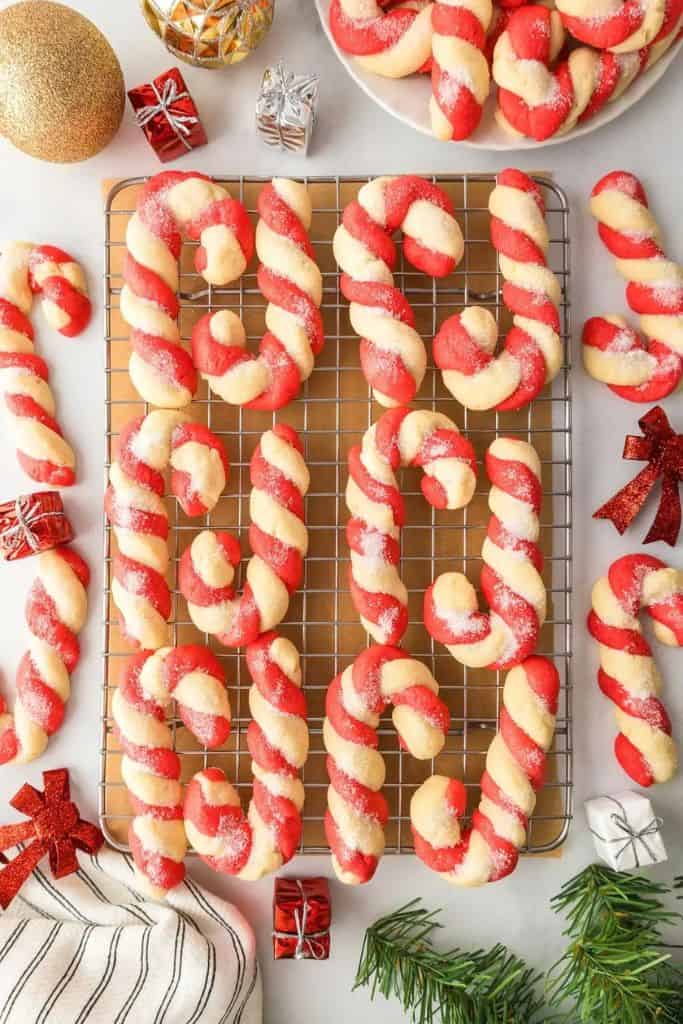 candy cane shaped cookies on wire rack.