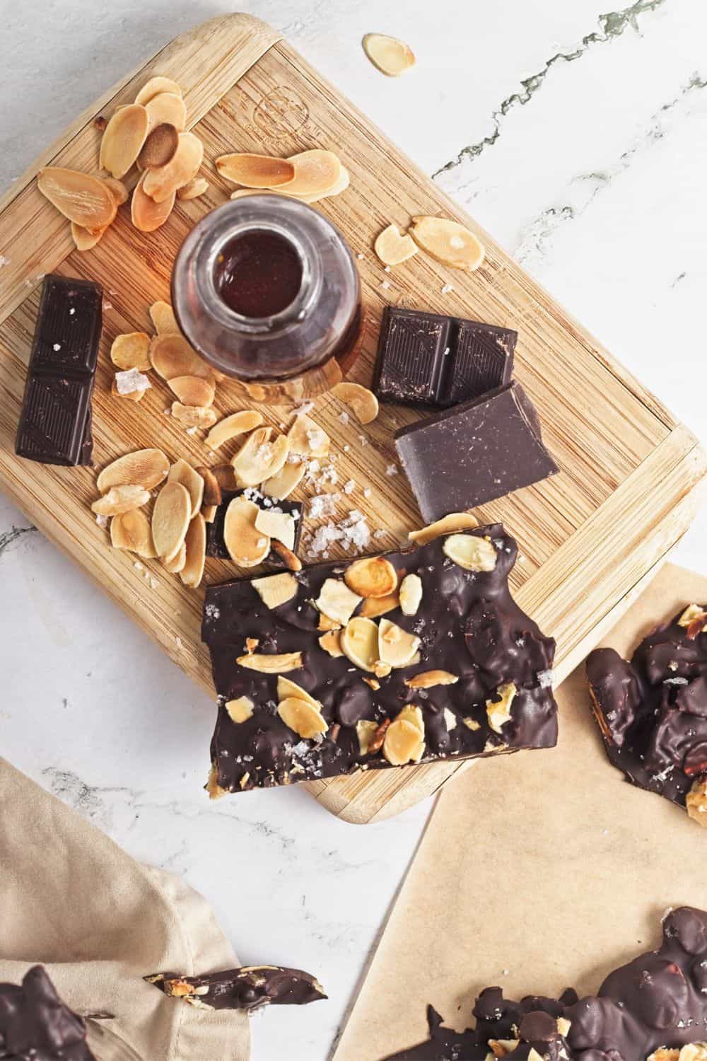 dark chocolate and almond bark pieces on board.