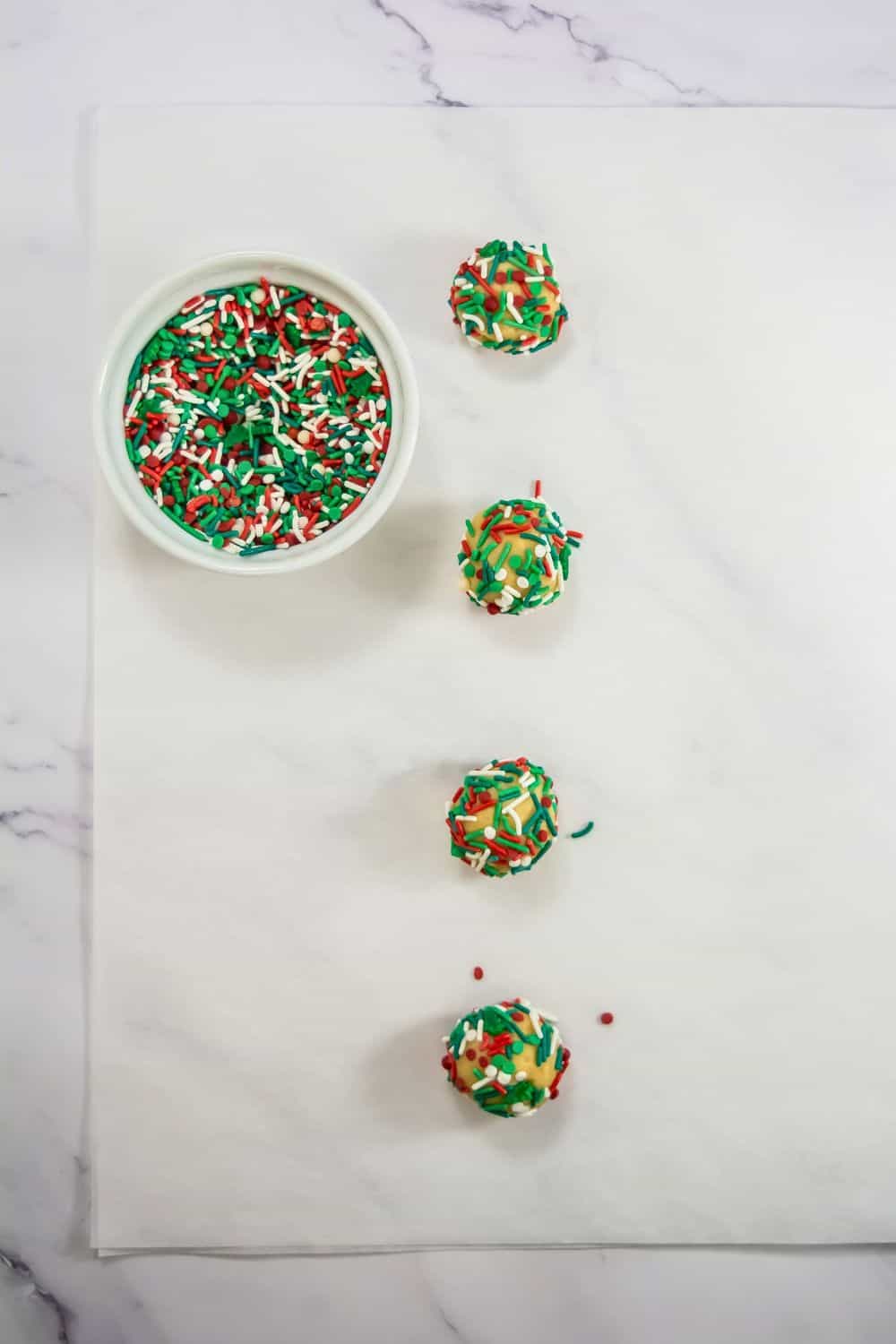 holiday cookie balls with festive sprinkles.