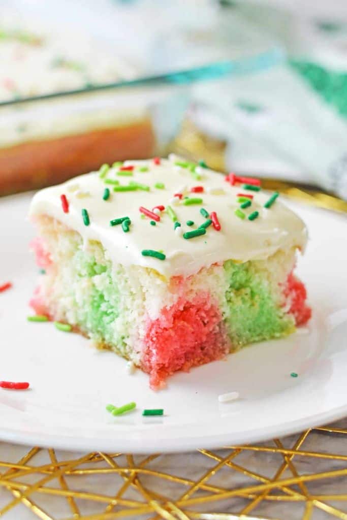 slice of red and green poke cake.