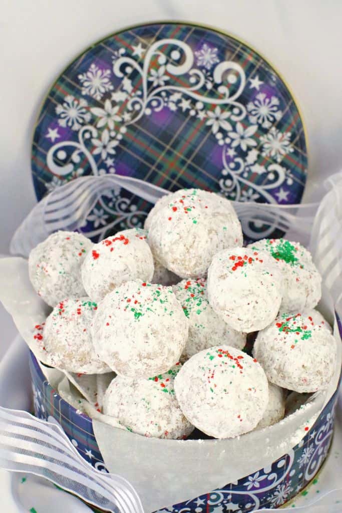 white snowball cookies in cookie tin.