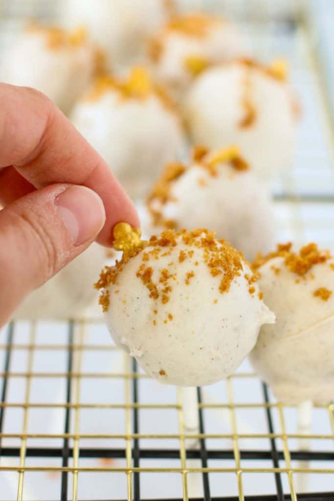 adding festive decorations to gingerbread cake pop.