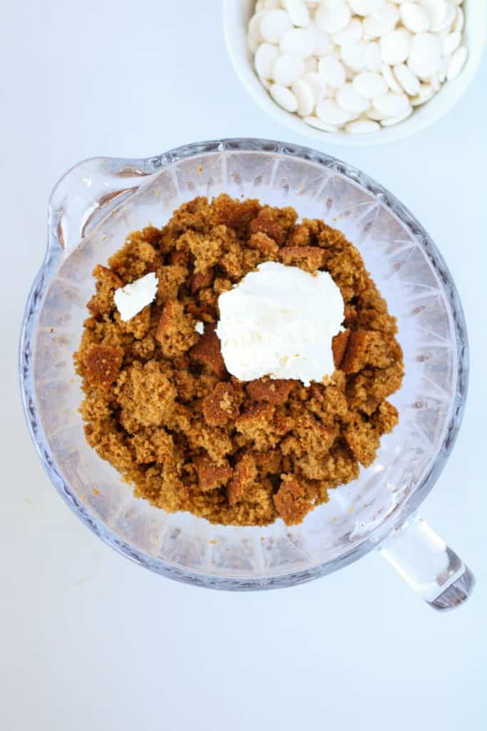 gingerbread cake crumbs and cream cheese in bowl.