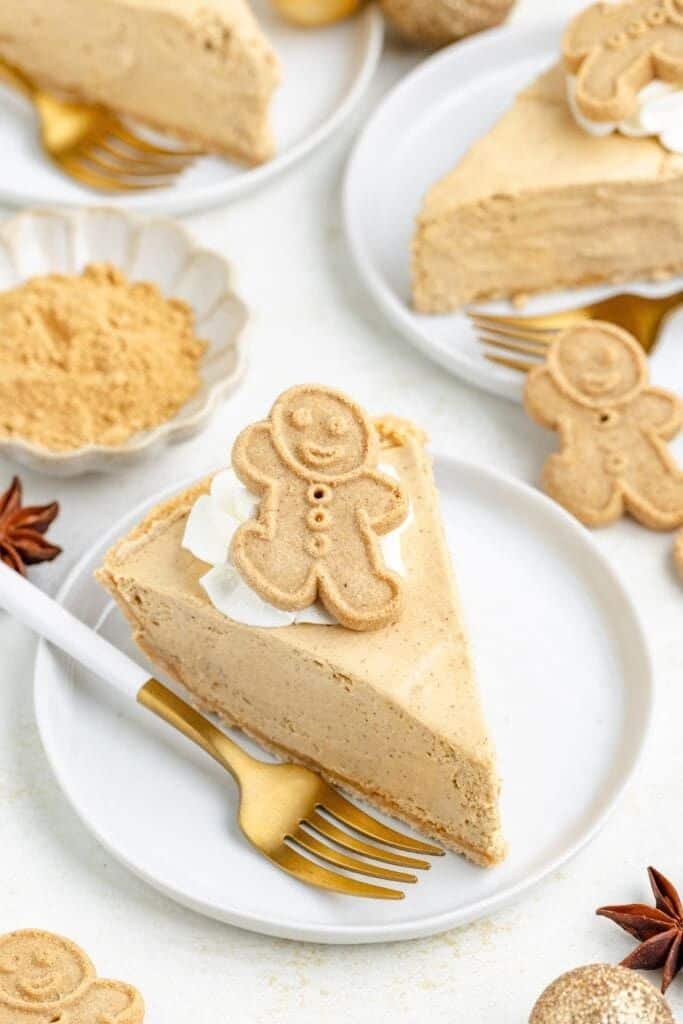 slice of gingerbread pie on plate with gingerbread cookie on top.