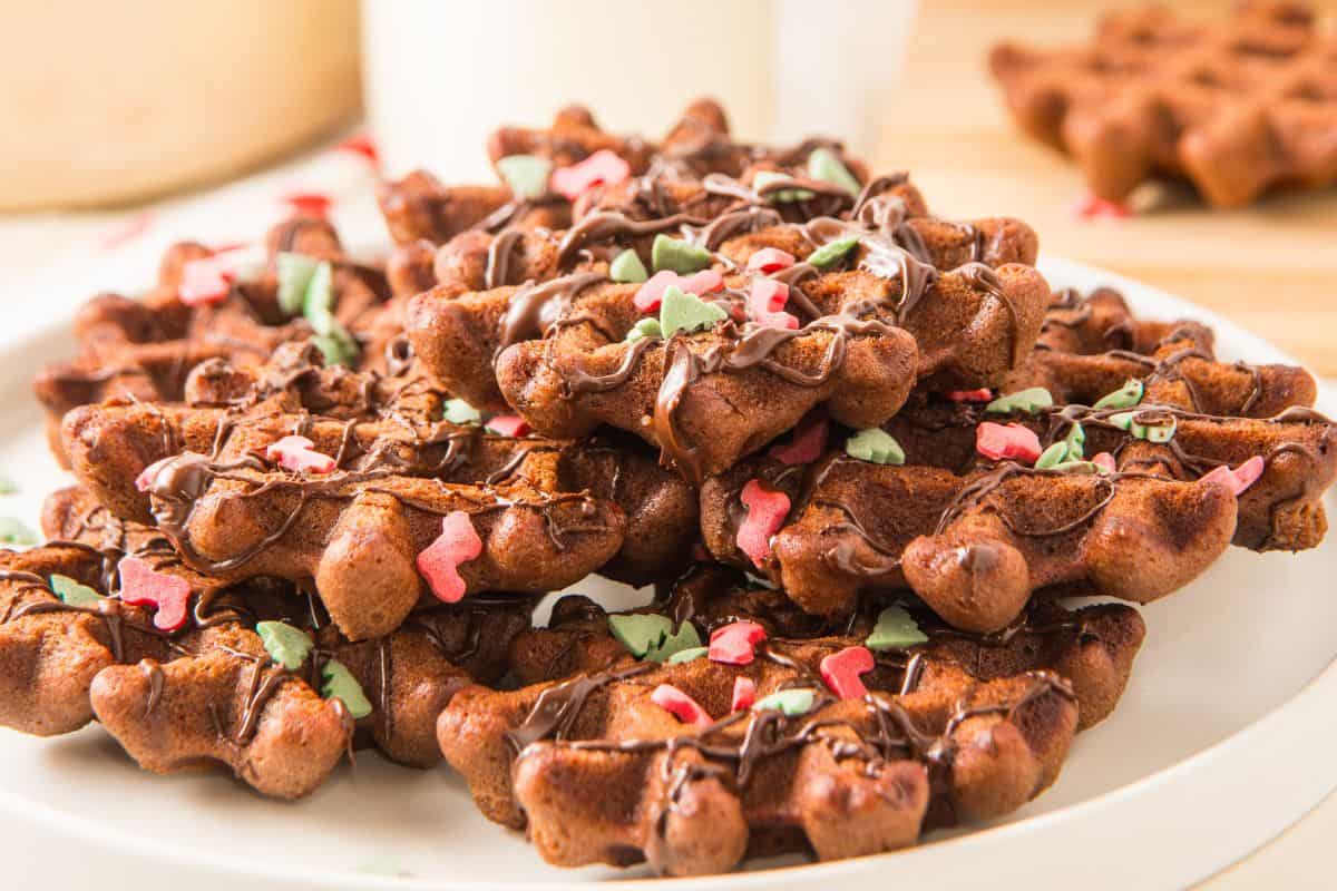 christmas cookies on plate with holiday sprinkles.