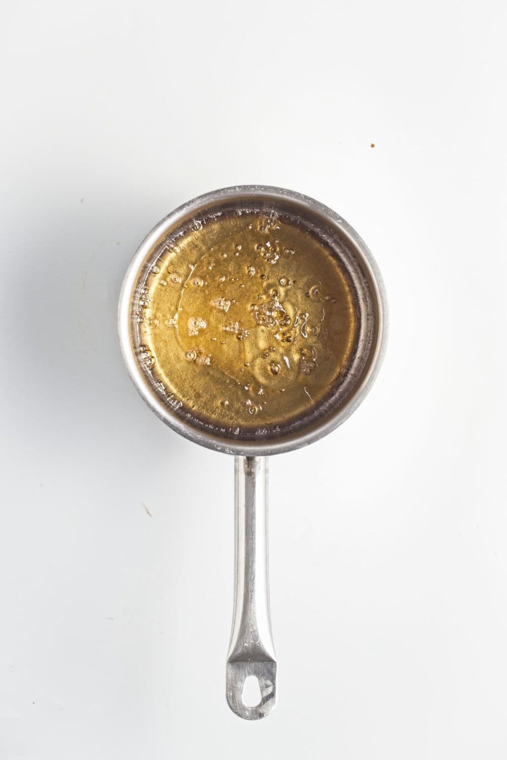 maple coconut syrup reducing in saucepan.