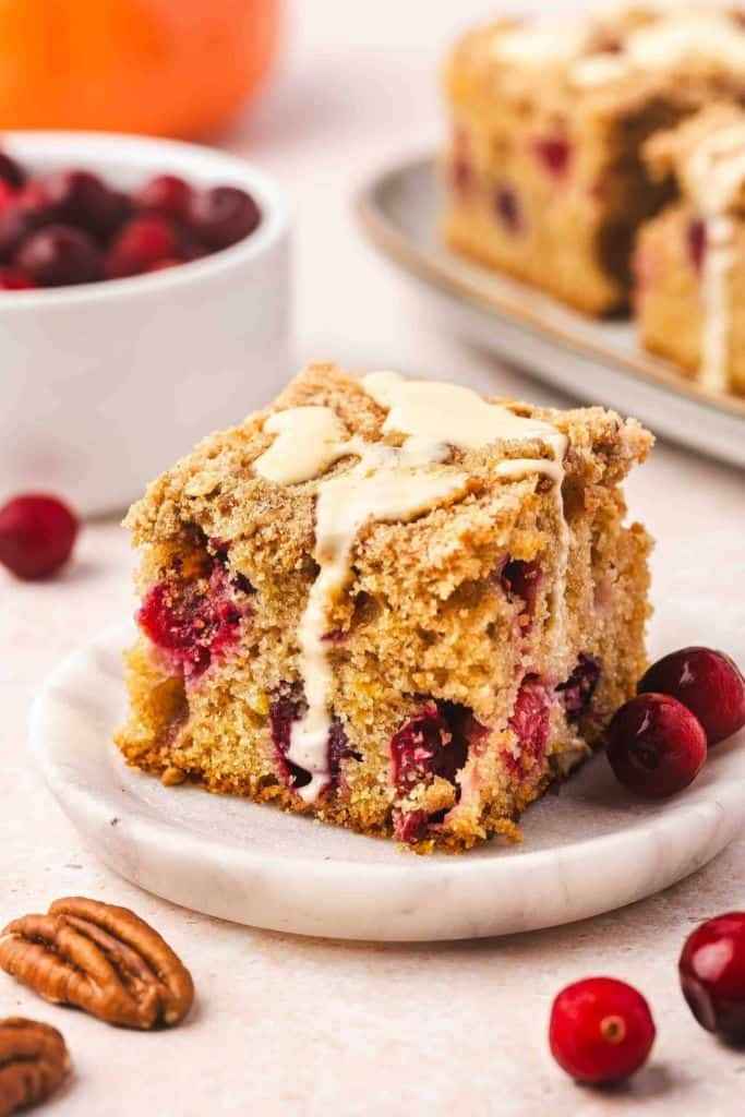 piece of glazed orange cranberry coffee cake on plate.