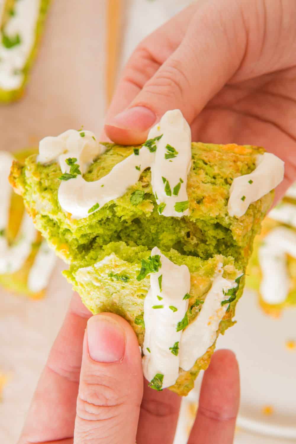 hands breaking open a savoury scone.