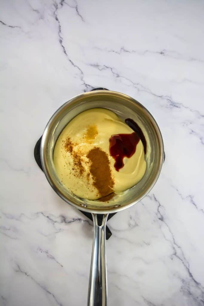 melted white chocolate with spices in pan.